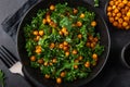 Vegan healthy kale and roasted chickpeas salad in black bowl