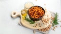 Vegan healthy snack, homemade roasted chickpeas in bowl on light gray background