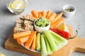 Vegan healthy snacks: guacamole, carrots, celery Royalty Free Stock Photo