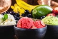 vegan ice cream made with organic fruits, with tropical fruits in the background, flavors of strawberry, banana, jabuticaba and