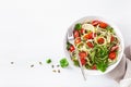 Vegan ketogenic spiralized courgette salad with avocado tomato pumpkin seeds