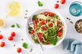 Vegan ketogenic spiralized courgette salad with avocado tomato pumpkin seeds