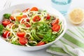 Vegan ketogenic spiralized courgette salad with avocado tomato pumpkin seeds