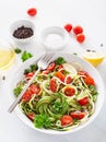 Vegan ketogenic spiralized courgette salad with avocado tomato pumpkin seeds