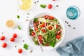 Vegan ketogenic spiralized courgette salad with avocado tomato pumpkin seeds