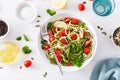 Vegan ketogenic spiralized courgette salad with avocado tomato pumpkin seeds