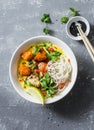 Vegan khao soi soup on a grey background, top view. Vegetarian soup with turmeric, rice noodles, baked pumpkin and cauliflower Royalty Free Stock Photo