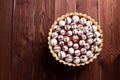 Vegan lemon tart decorated with Meringue kisses made from aquafaba, top view flatlay on brown wooden board with copy space Royalty Free Stock Photo