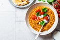 Vegan lentil soup with cilantro and tomato. Dal soup with tomatoes, top view. Indian cuisine concept Royalty Free Stock Photo