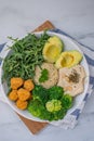 Vegan lunch bowl with quinoa, hummus, chickpeas, avocado, vegetables Royalty Free Stock Photo