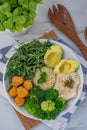 Vegan lunch bowl with quinoa, hummus, chickpeas, avocado, vegetables Royalty Free Stock Photo