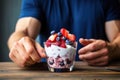vegan man eating coconut yogurt with mixed berries