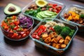 vegan meal prep bowls with quinoa, veggies, and avocado