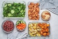 Vegan meal prep containers with  marinated tofu, beans, baked vegetables, green salad and vegetable sticks Royalty Free Stock Photo