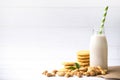 Vegan milk from cashews in bottles and cashew nut cookie on white wooden surface, Cashew nuts is used in most indian sweets
