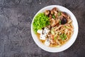 Vegan noodle soup with tofu cheese, shiitake mushrooms