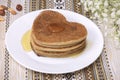 Vegan pancakes baked from dough on oatmeal, banana, nuts with honey and jam. Proper diet breakfast on a white plate