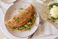 Vegan pancakes filled with mushrooms, pea sprouts, avocado. Eggs benedict with plant-based sauce, sourdough bread, tofu Royalty Free Stock Photo