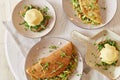 Vegan pancakes with mushrooms, pea sprouts, avocado. Eggs benedict with plant-based sauce, sourdough bread, tofu, young Royalty Free Stock Photo