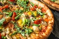 Vegan pizza with green bean pods, broccoli, cauliflower, tomatoes, bell peppers, mushrooms, peas, corn, arugula, olives and Royalty Free Stock Photo