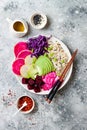 Vegan poke bowl with avocado, beet, pickled cabbage, radishes. Top view, overhead, flat lay.