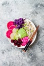 Vegan poke bowl with avocado, beet, pickled cabbage, radishes. Top view, overhead, flat lay.