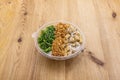 Vegan poke bowl with tofu, chopped white onion, wakame seaweed salad, crispy fried onion, sesame and poppy seeds Royalty Free Stock Photo