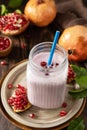 Vegan protein smoothie made from pomegranate and banana on a rustic wooden table. Healthy food, healthy lifestyle. Foodism, raw