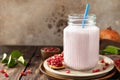 Vegan protein smoothie made from pomegranate and banana on a rustic wooden table. Healthy food, healthy lifestyle. Foodism, raw