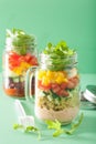 Vegan quinoa vegetable salad in mason jars