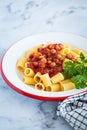 Vegan rigatoni pasta with chickpeas and tomato sauce in white plate Royalty Free Stock Photo