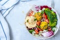 Vegan salad with falafel, hummus, vegetables