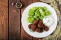 Baked beef meatballs and garnish from boiled cabbage romanesko Royalty Free Stock Photo