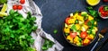 Vegan salad with sweet corn, avocado, jalapeno pepper, red tomatoes, fresh cilantro and olive oil and lime dressing. Black table Royalty Free Stock Photo