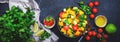 Vegan salad with sweet corn, avocado, jalapeno pepper, red tomatoes, fresh cilantro and olive oil and lime dressing. Black table Royalty Free Stock Photo