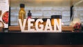 Vegan Sign on Ethical Cosmetics Section Shelf in Shopping Mall. 4K.