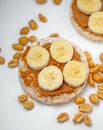 Vegan snacks. Rice cakes with peanut butter sliced banana on white background. healthy snacks for children.