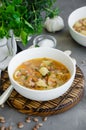 Vegan soup with beans and pasta in a bowl on a board on a dark concrete background. Vertical orientation Royalty Free Stock Photo