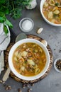 Vegan soup with beans and pasta in a bowl on a board on a dark concrete background. Vertical orientation. Top view Royalty Free Stock Photo