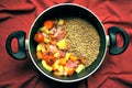 Vegan soup with lentils and fresh, organic vegetables in a pan