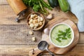 Vegan soup puree of green vegetables. Bowl of green bean and zucchini cream soup on a rustic table. Healthy diet low carb. View