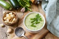 Vegan soup puree of green vegetables. Healthy diet low carb. Bowl of green bean and zucchini cream soup on a rustic table