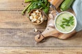 Vegan soup puree of green vegetables. Healthy diet low carb. Bowl of green bean and zucchini cream soup on a rustic table. View