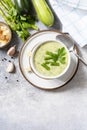 Vegan soup puree of green vegetables. Healthy food. Bowl of green bean and zucchini cream soup on a stone table. View from above.