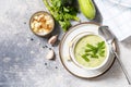 Vegan soup puree of green vegetables. Healthy food. Bowl of green bean and zucchini cream soup on a stone table. View from above.