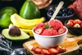Vegan strawberry ice cream with tropical fruits in the background, strawberry, banana, avocado and jabuticaba