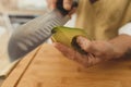 vegan sushi. Close up wide angle asian sushi master slicing avocado with knife