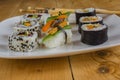 Vegan sushi on plate on wood table and chopsticks Royalty Free Stock Photo