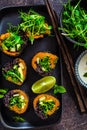 Vegan sushi rolls with black rice, avocado and sweet potato on black dish. Vegan food concept Royalty Free Stock Photo