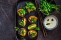 Vegan sushi rolls with black rice, avocado and sweet potato on black dish. Vegan food concept Royalty Free Stock Photo